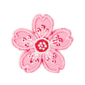 May include: Pink embroidered flower patch with a white center and red accents.