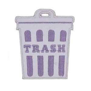 May include: Purple embroidered iron-on patch of a trash can with the word "TRASH" in white letters.