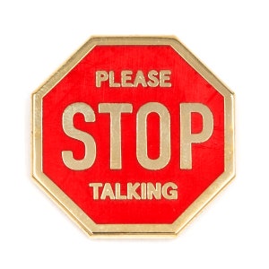 May include: A red octagonal stop sign with gold trim and the text "PLEASE STOP TALKING" in white.