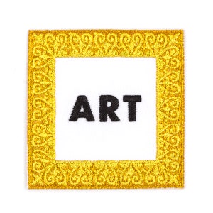May include: Gold embroidered patch with a white background and the word "ART" in black lettering.