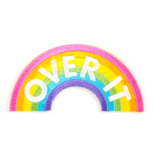 May include: A rainbow-colored embroidered patch with the word "OVER IT" in white lettering.