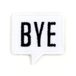 May include: White fabric patch with a speech bubble shape and the word "BYE" in black embroidered letters.