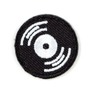 May include: Black and white embroidered iron-on patch of a vinyl record.
