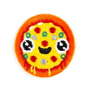 May include: A round, embroidered iron-on patch of a smiling pizza with red, green, and white toppings. The pizza has a yellow crust and a red, orange, and yellow border.