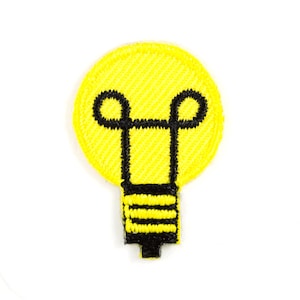 May include: A yellow light bulb shaped iron-on patch with a black outline.