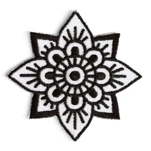 May include: Black and white embroidered patch with a mandala design. The patch has a flower shape with a circular pattern in the center.