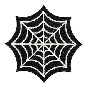 May include: Black fabric patch with a white embroidered spider web design.