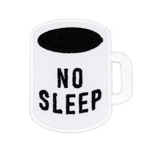 May include: White embroidered patch in the shape of a coffee mug with a black oval at the top. The words "NO SLEEP" are embroidered in black, centered on the mug.
