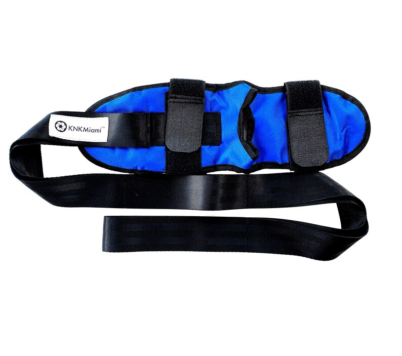 May include: Blue ankle support with adjustable straps and a black strap with the text "KNKMiami" printed on it.