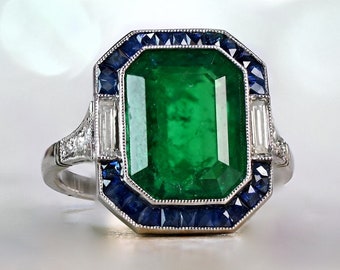 4.49ct GIA-Certified Emerald Cut Emerald and Diamond Ring with a Halo Sapphire Accent. Platinum Ring.