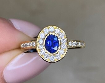 Vintage 0.40ct Oval Cut Sapphire Ring with a Halo Diamond Accent, Circa 1980. Handcrafted in 18K Yellow Gold Ring.