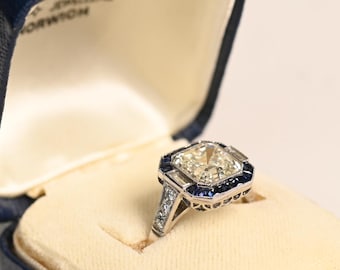 GIA-Certified 3.08center-ct Asscher Cut Diamond Ring. Bezel Set Diamond Ring. Halo French Cut Sapphire Accent. Handcrafted in Platinum Ring.