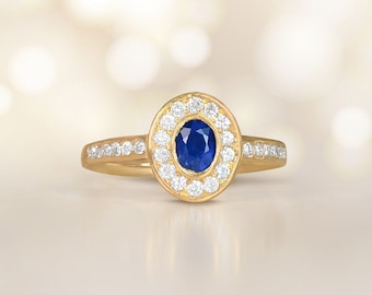Vintage 0.40ct Oval Cut Sapphire Ring with a Halo Diamond Accent, Circa 1980. Handcrafted in 18K Yellow Gold Ring.