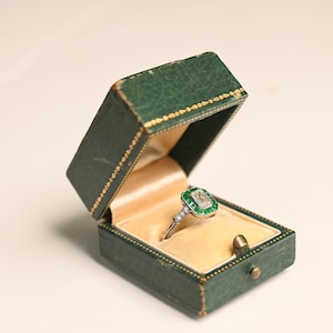 0.80center-ct GIA-Certified Emerald Cut Diamond Ring. Halo Natural Green Emerald Accent. Handcrafted Platinum Ring H Color and VS2 Clarity.