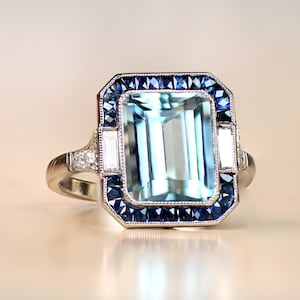 Emerald-Cut Aquamarine and Diamond Ring with Halo Sapphire Accent. Platinum Ring. image 1