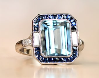 Emerald-Cut Aquamarine and Diamond Ring with Halo Sapphire Accent. Platinum Ring.