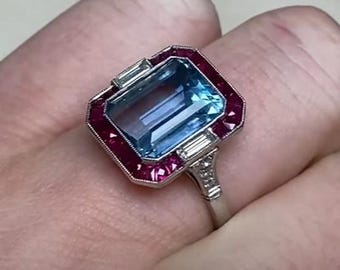 3.25center-ct Emerald Cut Rich Light Blue Aquamarine and Diamond Ring. Halo of Caliber Cut Rubies Set Ring. Handcrafted in Platinum Ring.