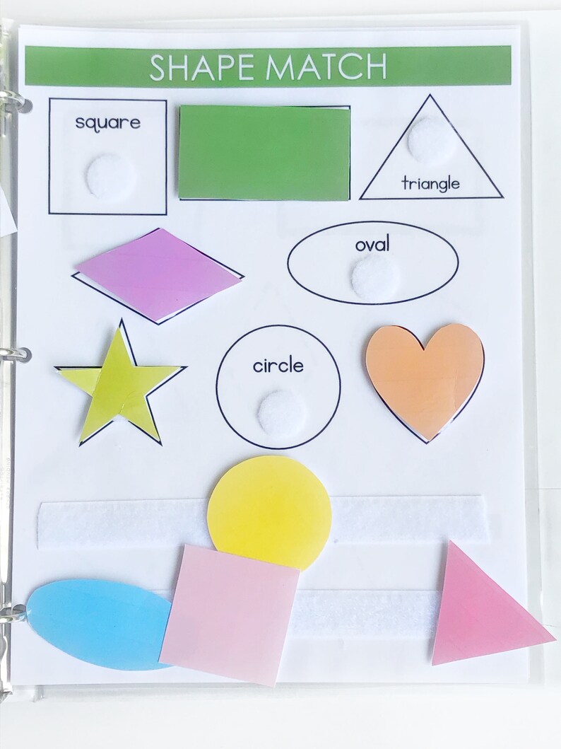 May include: A white board with the words "SHAPE MATCH" at the top.  There are different shapes with names below them: square, triangle, oval, circle.  There are also colorful shapes that can be matched to the outlines.