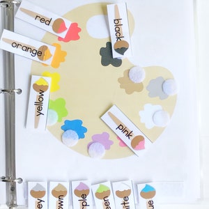 May include: A color palette learning tool with a paint palette and color cards. The cards have a paintbrush icon and the words: red, orange, yellow, green, blue, purple, brown, grey, white, pink, and black.