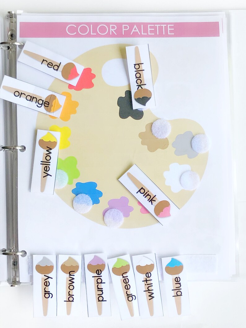 May include: A color palette learning tool with a paint palette and color cards. The cards have a paintbrush icon and the words: red, orange, yellow, green, blue, purple, brown, grey, white, pink, and black.