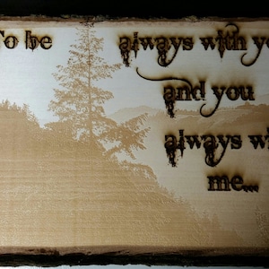 May include: Wooden plaque with a landscape scene and the words "To be always with you and you always with me..." burned into the wood. The artwork features a tree and mountain range in a light brown color.