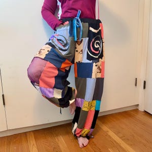 May include: Patchwork pants in a variety of colors, including pink, purple, blue, and black. The pants have a drawstring waist and a loose, comfortable fit. The patchwork design features various patterns and textures.