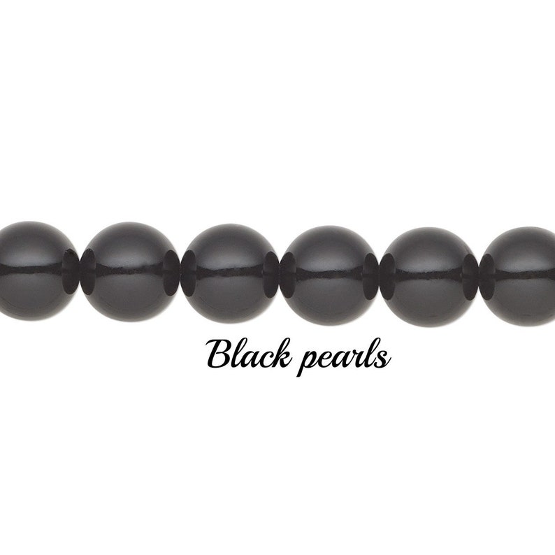 May include: A strand of glossy, black pearls. The round beads are strung together, with the text "Black pearls" in a cursive font below the pearls. The pearls are set against a white background.