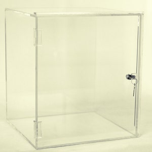 May include: A clear acrylic display case with a lock and key. The case has a hinged door and is made of thick, durable acrylic.