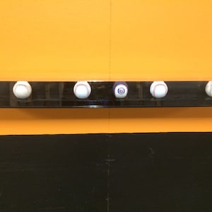 12 baseball or hockey puck wall mount display case with black base UV filtering MLB NHL