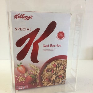 May include: A box of Kellogg's Special K Red Berries cereal. The box is red and white with a large 'K' logo. The cereal is made with crunchy wheat and rice flakes with real strawberries. The box is in a clear acrylic display case.