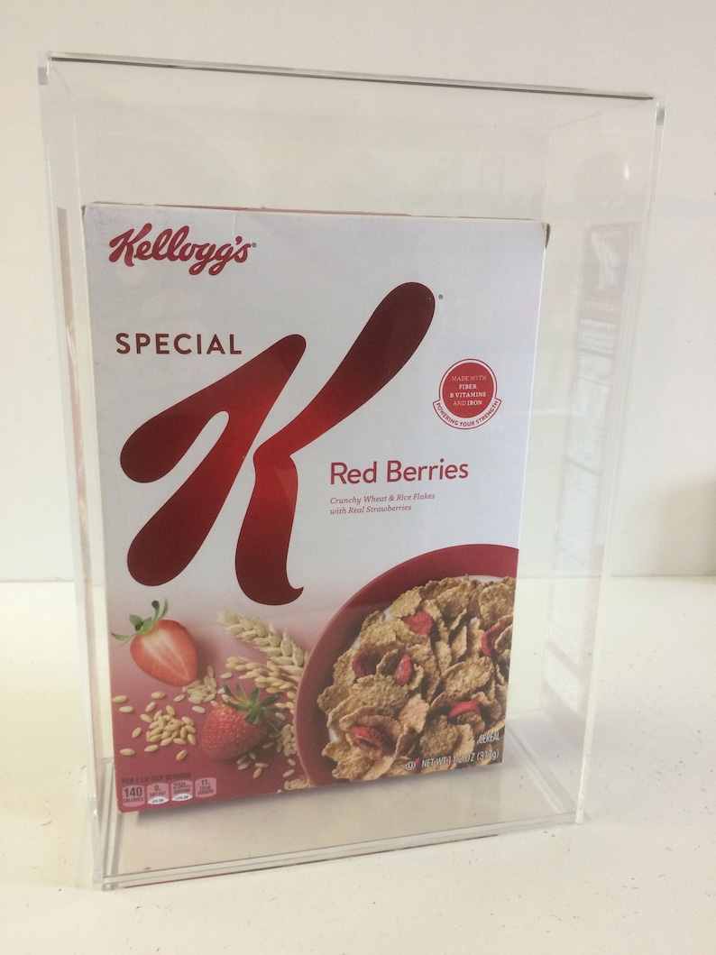 May include: A box of Kellogg's Special K Red Berries cereal. The box is red and white with a large 'K' logo. The cereal is made with crunchy wheat and rice flakes with real strawberries. The box is in a clear acrylic display case.
