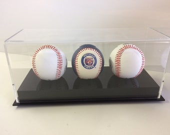 May include: Three baseballs in a clear acrylic display case. The middle baseball has a Detroit Tigers logo. The case has a black base.