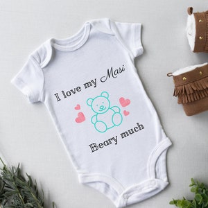 May include: White baby onesie with the text "I love my Masi Beary much" and a cartoon blue teddy bear with pink hearts.