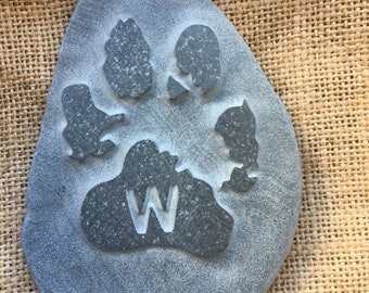 Have the paw print of your loved furry friend hand carved into natural stone, customised and personal with their initial