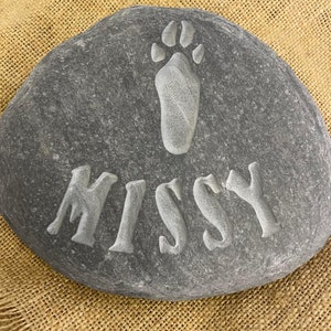 Hand carved memory stone of a bunny rabbit with a rabbit paw print above the name of your loved furry friend