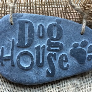 Dog House! A fun hand carve stone wall hanging, made from natural stone with raised lettering!