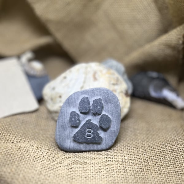 Paw print into stone or pebble, hand carved from an ink print, with initial. Memory keepsake, memorial stone, pet grave marker, personalised