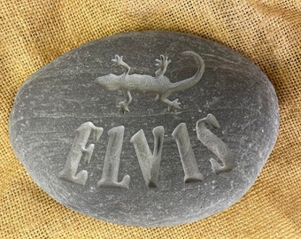 Hand carved memory stone including the name of your loved one, with the silhouette of a lizard/gecko above