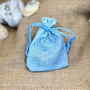 May include: A small blue drawstring bag made of burlap fabric.