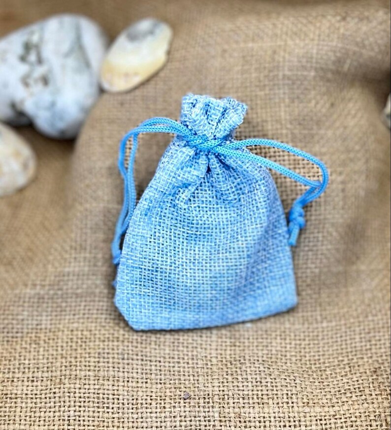 May include: A small blue drawstring bag made of burlap fabric.