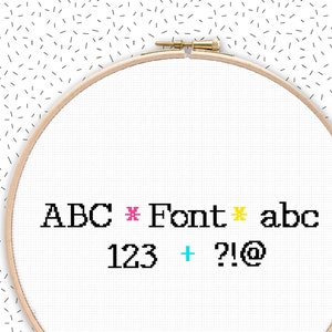 May include: A white embroidery hoop with the text "ABC * Font * abc 123 + ?!@" in black, pink, yellow, and turquoise.