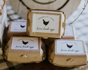 May include: Four brown cardboard egg cartons with white labels that say "Annabelle's Farm farm fresh eggs" and a black silhouette of a chicken.