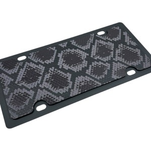 May include: Black license plate frame with a snakeskin pattern.