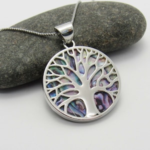 May include: A silver necklace with a round pendant featuring a tree of life design. The tree is made of iridescent abalone shell with a silver outline.
