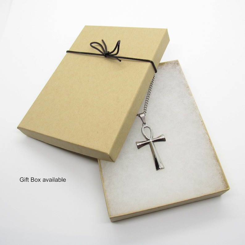 May include: A silver Ankh pendant necklace in a brown gift box with a black ribbon.  Gift Box available.