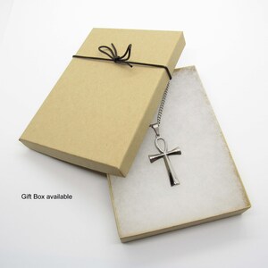 May include: A silver Ankh pendant necklace in a brown gift box with a black ribbon.  Gift Box available.
