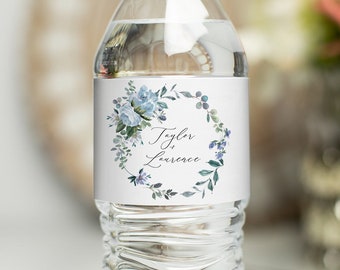 May include: A white water bottle with a blue floral wreath and the text "Tyler & Lawrence" on a label.