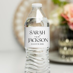 May include: A clear plastic water bottle with a white label that reads "SARAH and JACKSON AUGUST 16, 2023".