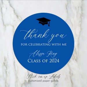 May include: Blue round sticker with a black graduation cap, white text that says "thank you for celebrating with me Alissa King CLASS OF 2024" and the text "Stick em up Labels customized paper goods."