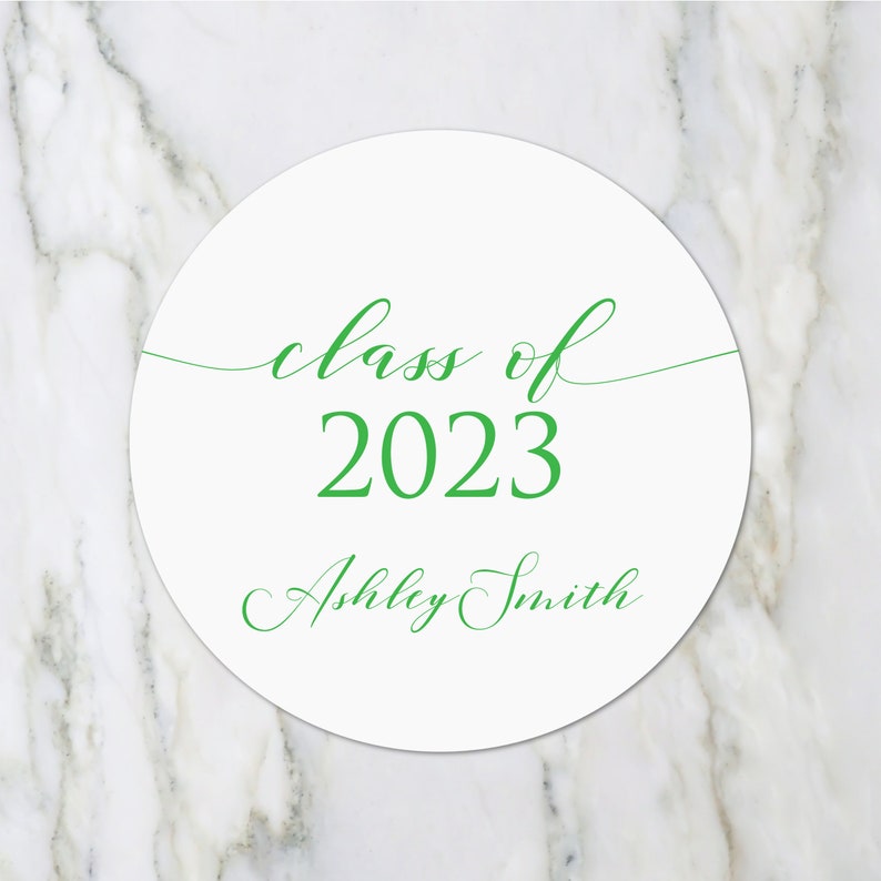 May include: White circle sticker with green text that reads "class of 2023" and "Ashley Smith".